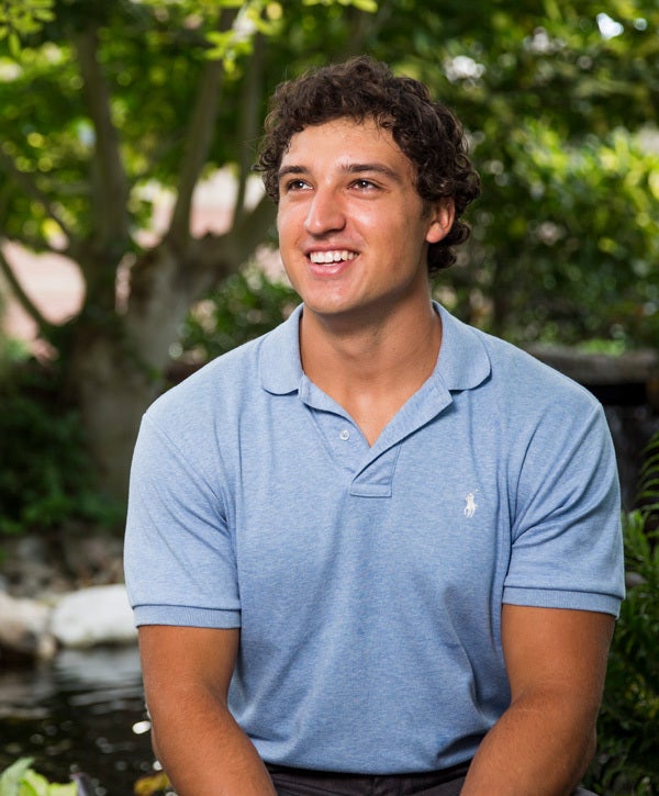 male ucf student sitting outside