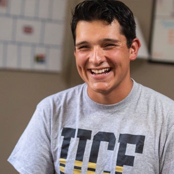 male ucf student smiling while talking to counselor