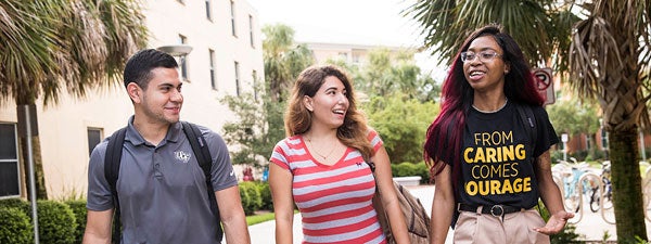 three students walking on campus