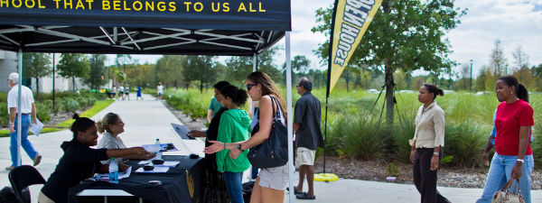 students checking in for open house outside