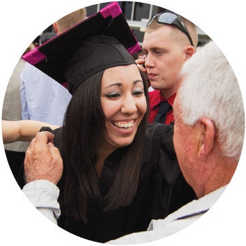 female ucf student graduating and smiling