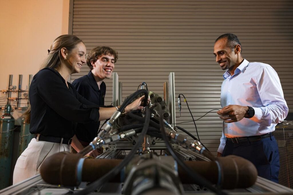 Two graduate students work with professor Kareem Ahmed in the UCF Hyperspace Research Center