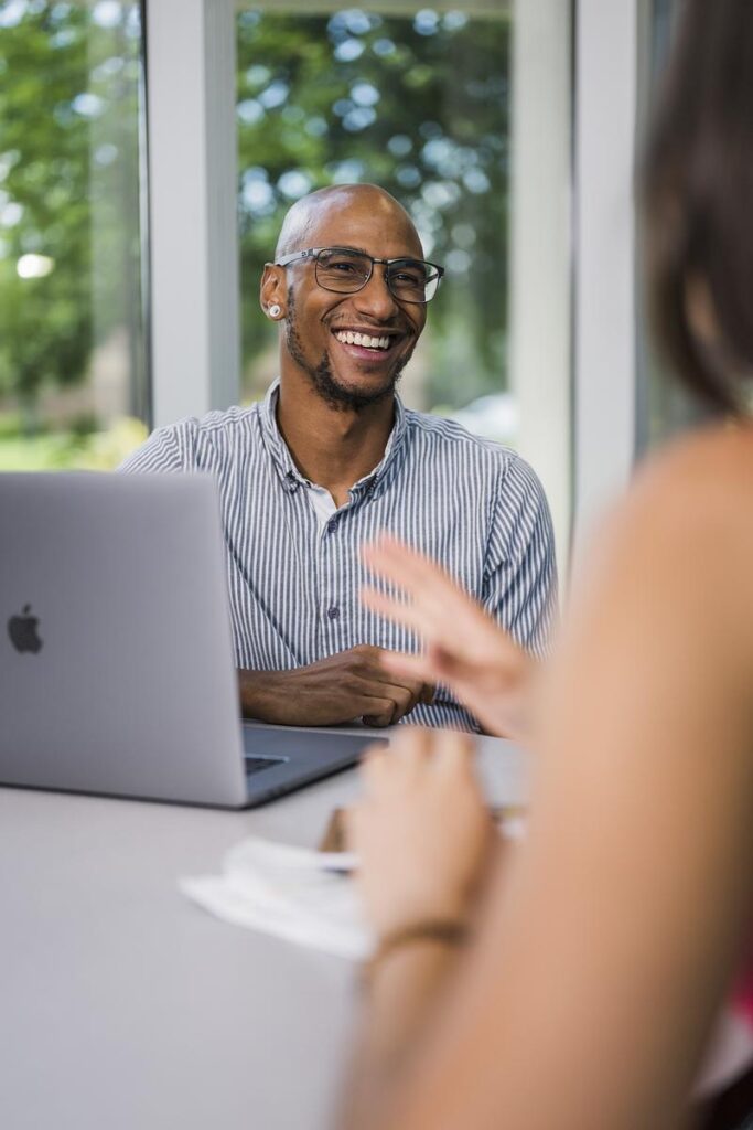 A student smiles while studying in UCF's hallways.
