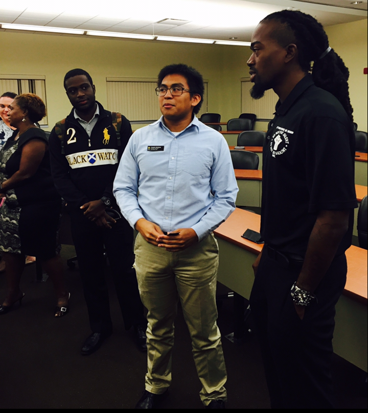 UCF students (L-R) Patrick Isidore and Angelo Baldado talk to social justice activist Miles Mulrain Jr.