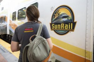 Picture of student and Sunrail train