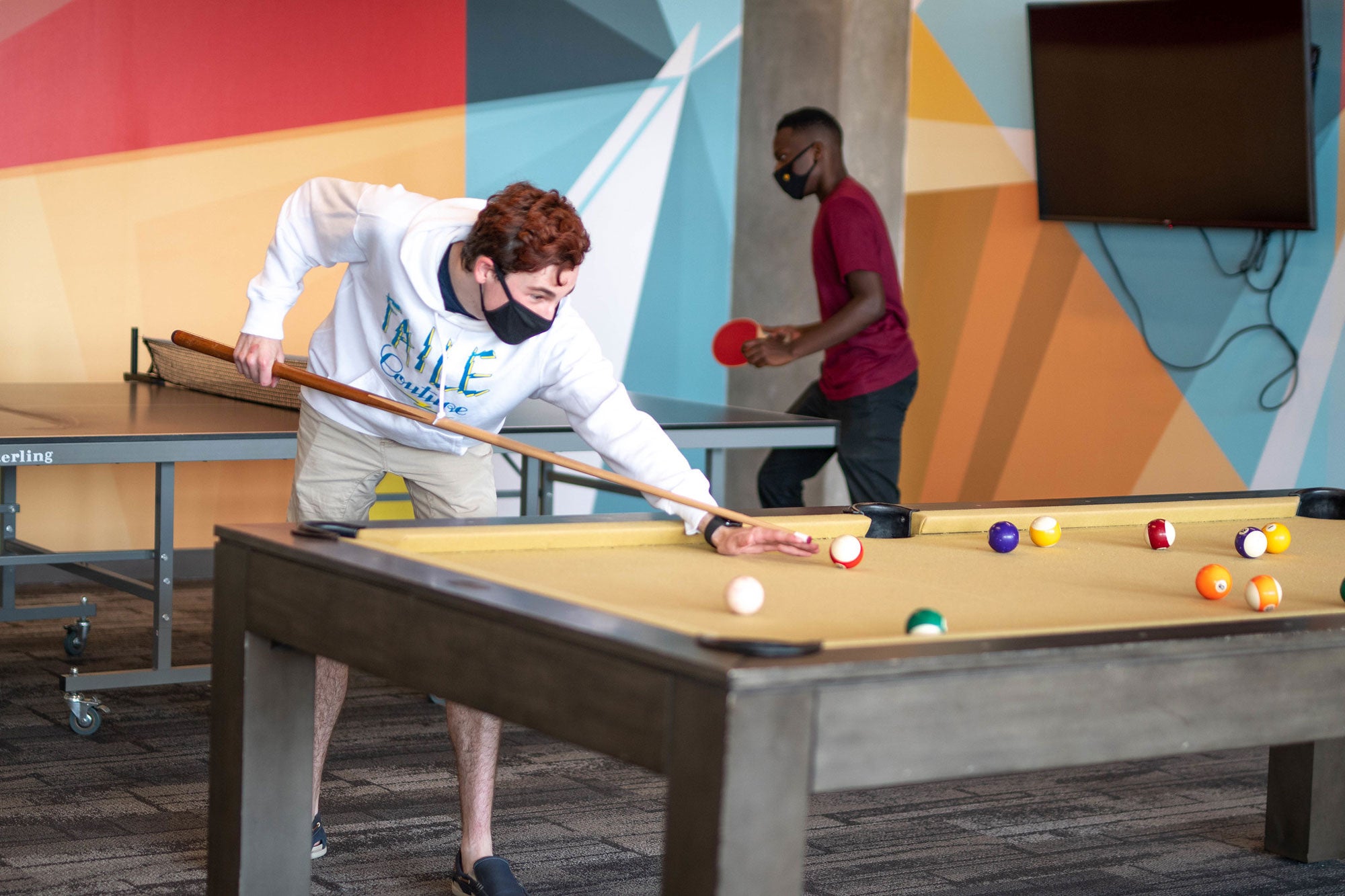 student playing pool