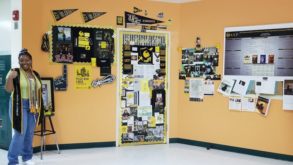 photo of student in front of decorated wall