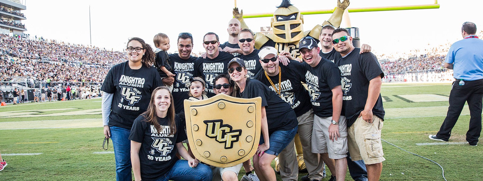 group of ucf students standing together on the football field
