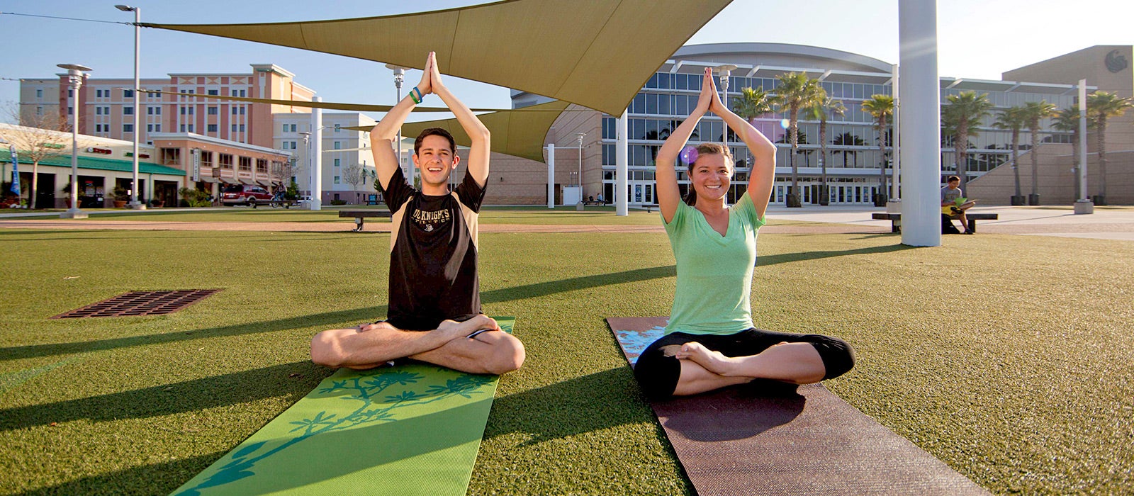 two students doing yoga at ucf