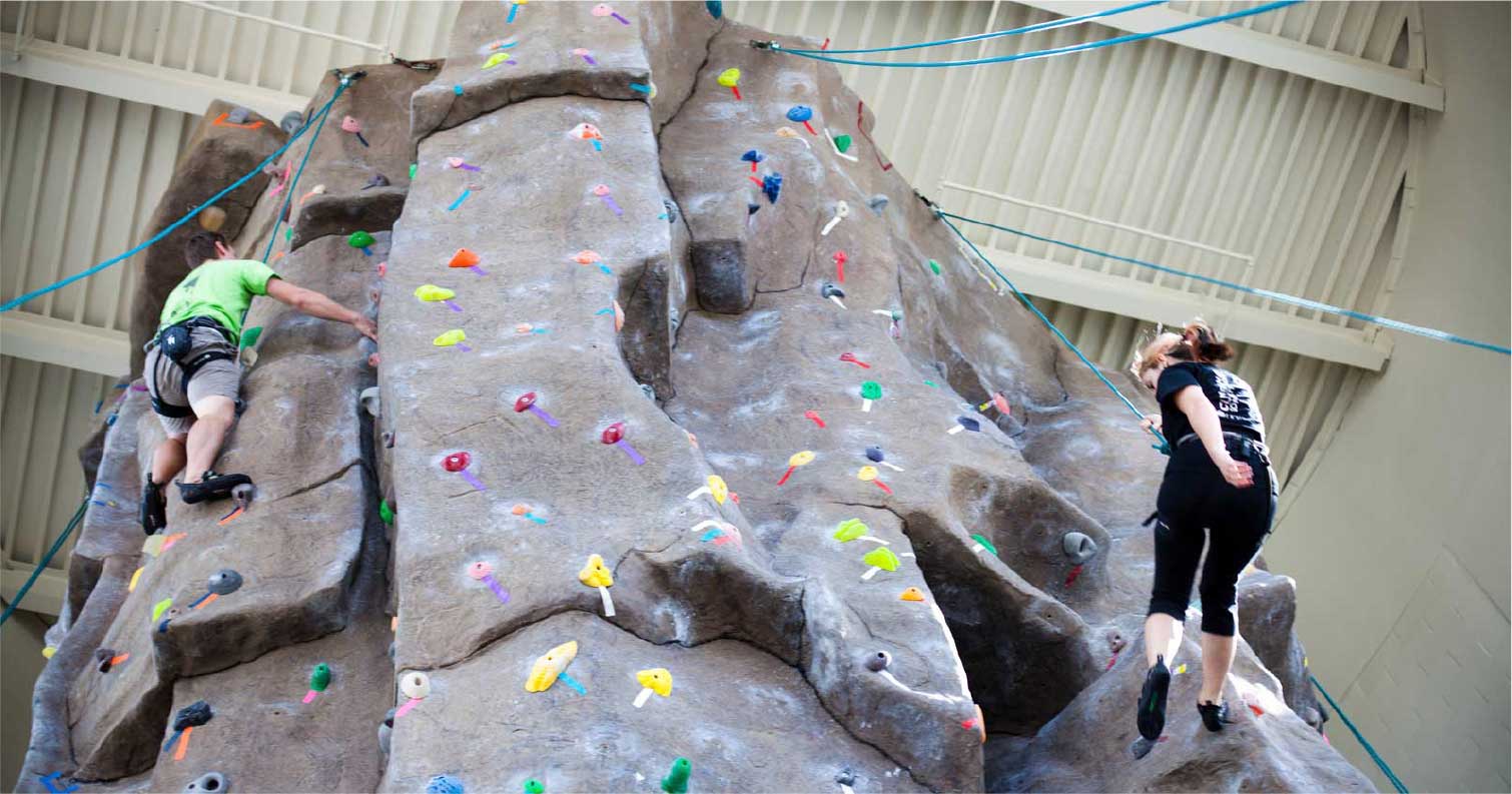 ucf students climbing rock wall in ucf gym