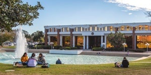 UCF students sitting by the Reflecting Pond