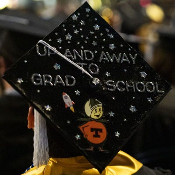Graduation cap with Up and Away to Grad School