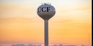 The water tower with the letters "UCF" during sunrise.
