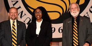 President Cartwright and Provost Johnson pose Dr. Leah Gaines