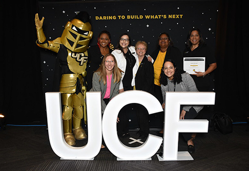 A photo of Knightro with 2026 Founders Day awardees.