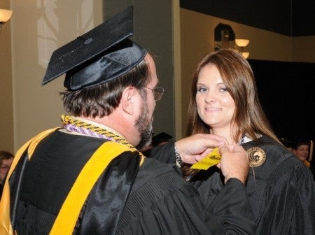 Cocoa student Meredith Willis is pinned by Stephen Heglund. Photo: Santiago Studios