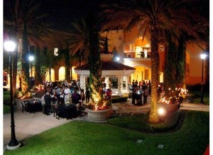 Guests enjoy the evening celebration in the Rosen College courtyard.