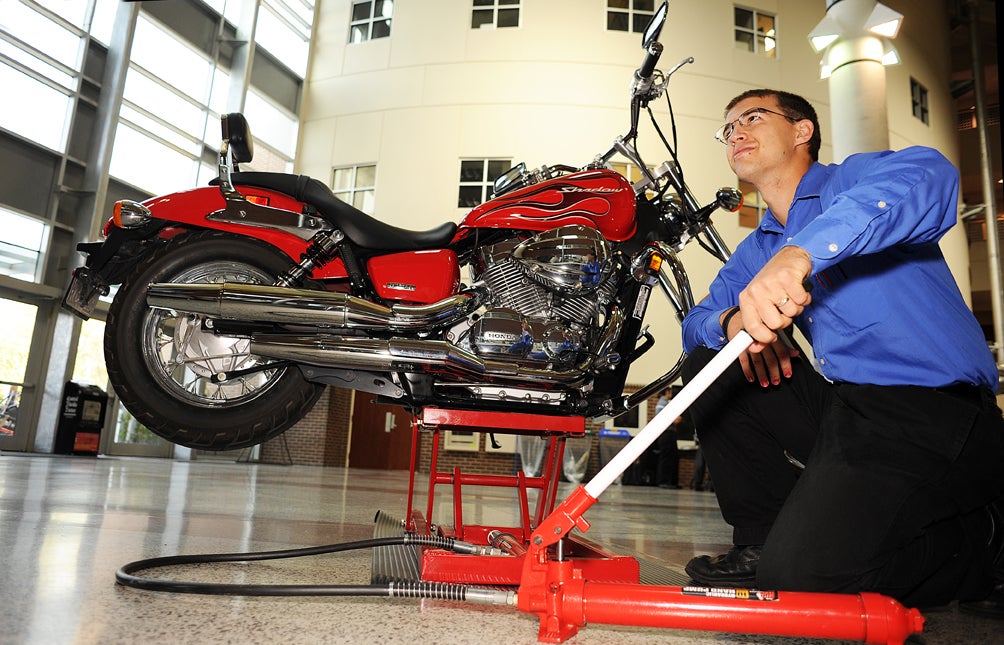 Chester Rowe tries out his team's motorbike jack