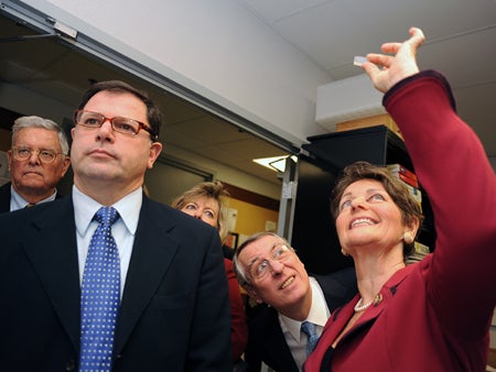 U.S. Assistant Secretary of Commerce John Fernandez (left) and Congresswoman Suzanne Kosmas toured College of Optics and Photonics laboratories.