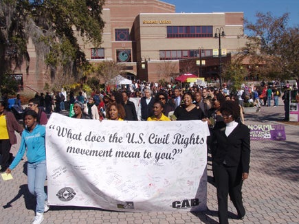 Students, faculty and staff march from the Student Union to the Reflecting Pond.