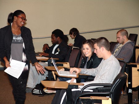 Student-athletes working on their homework in the Football Study room.