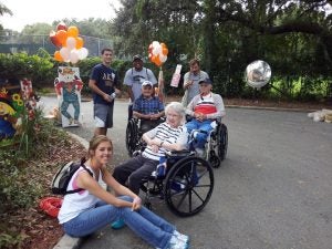 UCF students take a break from decorating to spend time with a few residents of Winter Park Towers.
