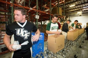 Jacob Serre helps to pack emergency food boxes. (Photo: Scott Mitchell Photography)