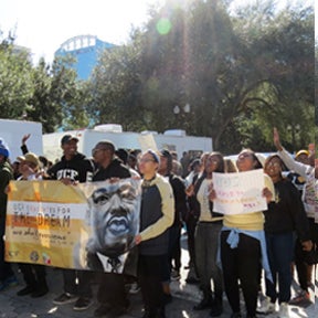 UCF students honor MLK and march in a parade Downtown Orlando.