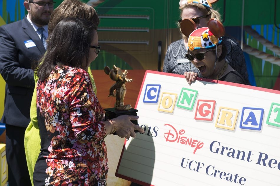 During a special ceremony, Disney presented UCF CREATE Director Stella Sung with a Mickey Mouse trophy in recognition of the $100,000 grant being awarded to the university.