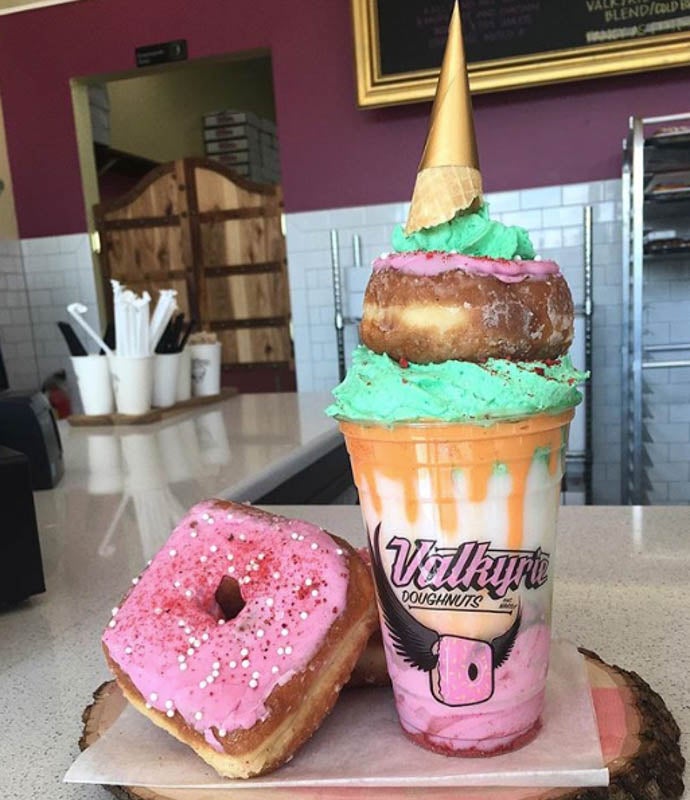 Very Berry Bulls#@$ Drank — made with their very berry soft serve and drizzle, pink whip, a mini doughnut and mini cone hat