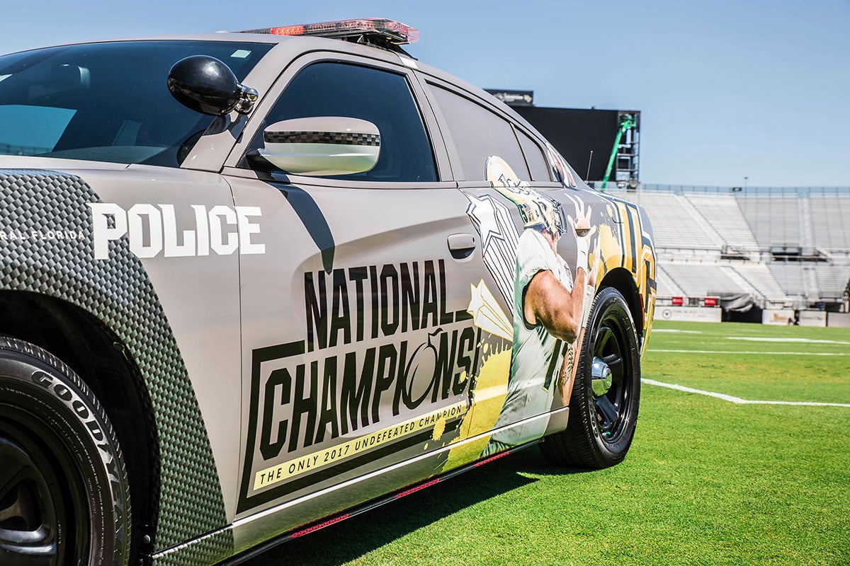 gray police car with "national champions" and image of a receiver detailing the side of the car