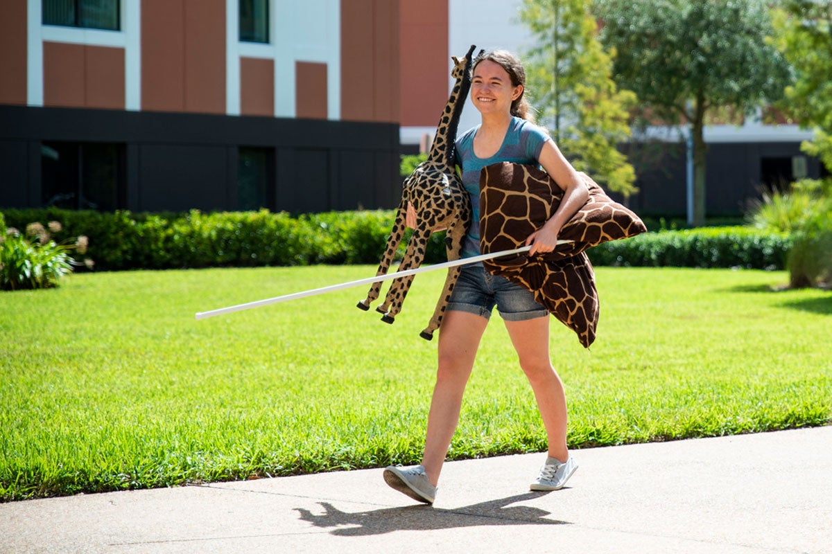 UCF student carrying stuffed animals
