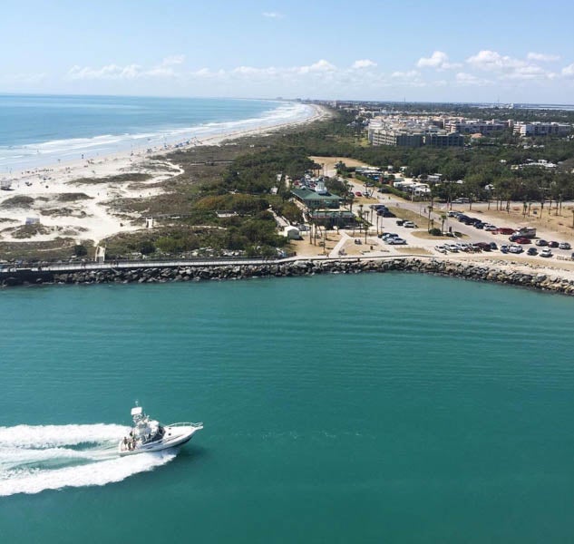 aerial view of boat passing by edge of Banana River