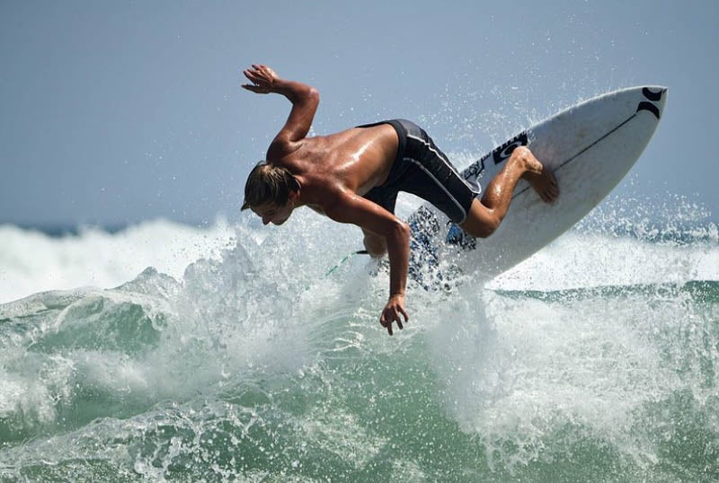 man surfing big waves on Melbourne beach