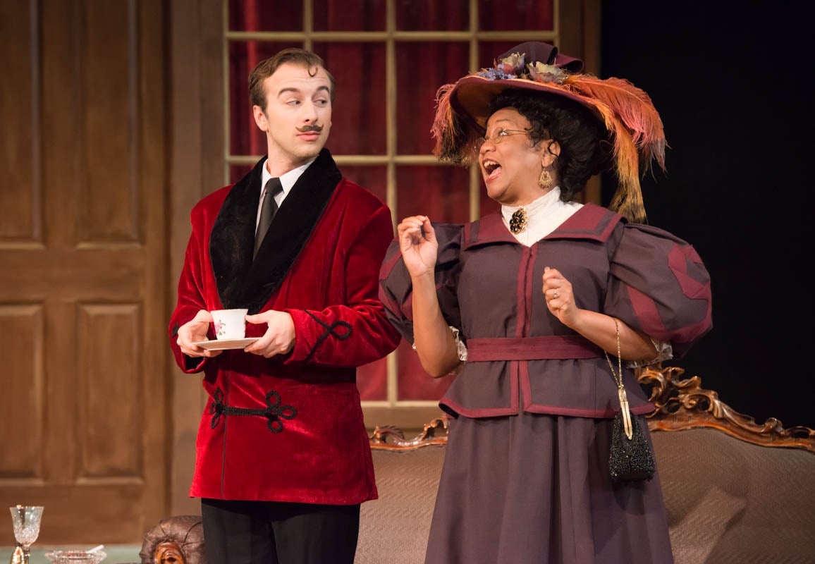 A man and a woman wearing theater costumes.