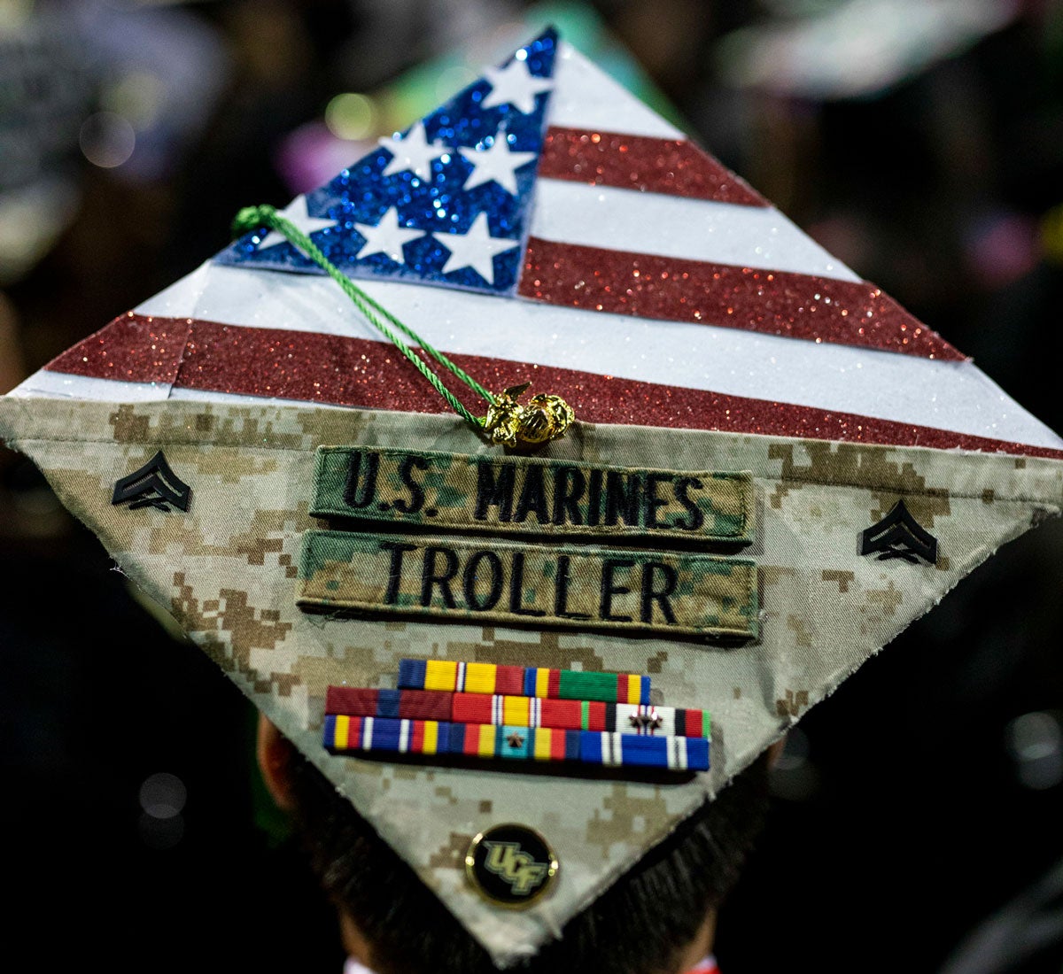 Graduation cap decorated with American flag and U.S Marines service ribbons