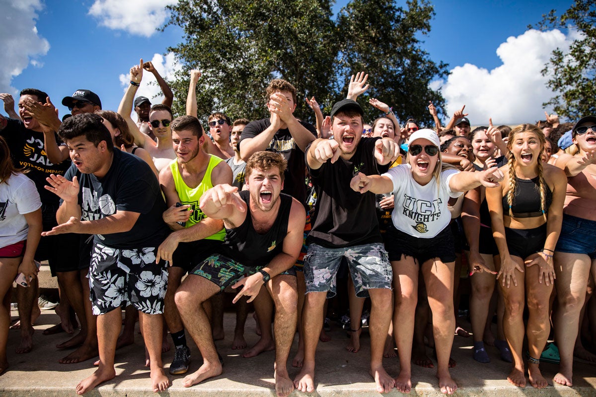 closeup of college students cheering outside 