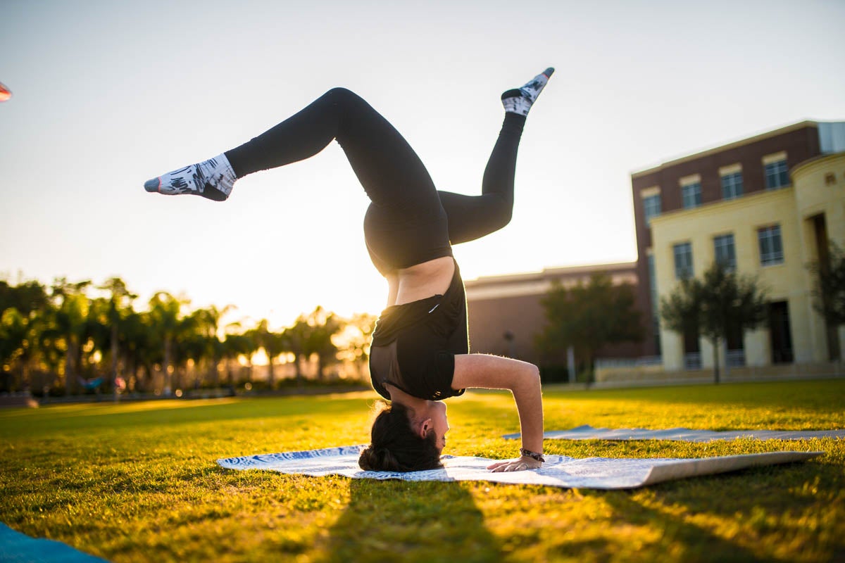 A student takes some time between classes to stretch out on Memory Mall