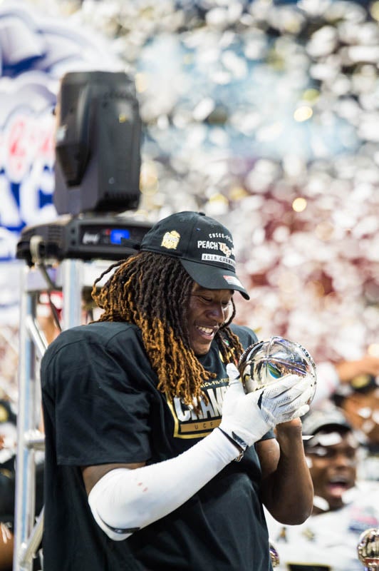 former UCF linebacker Shaquem Griffin ’16 admires the championship trophy