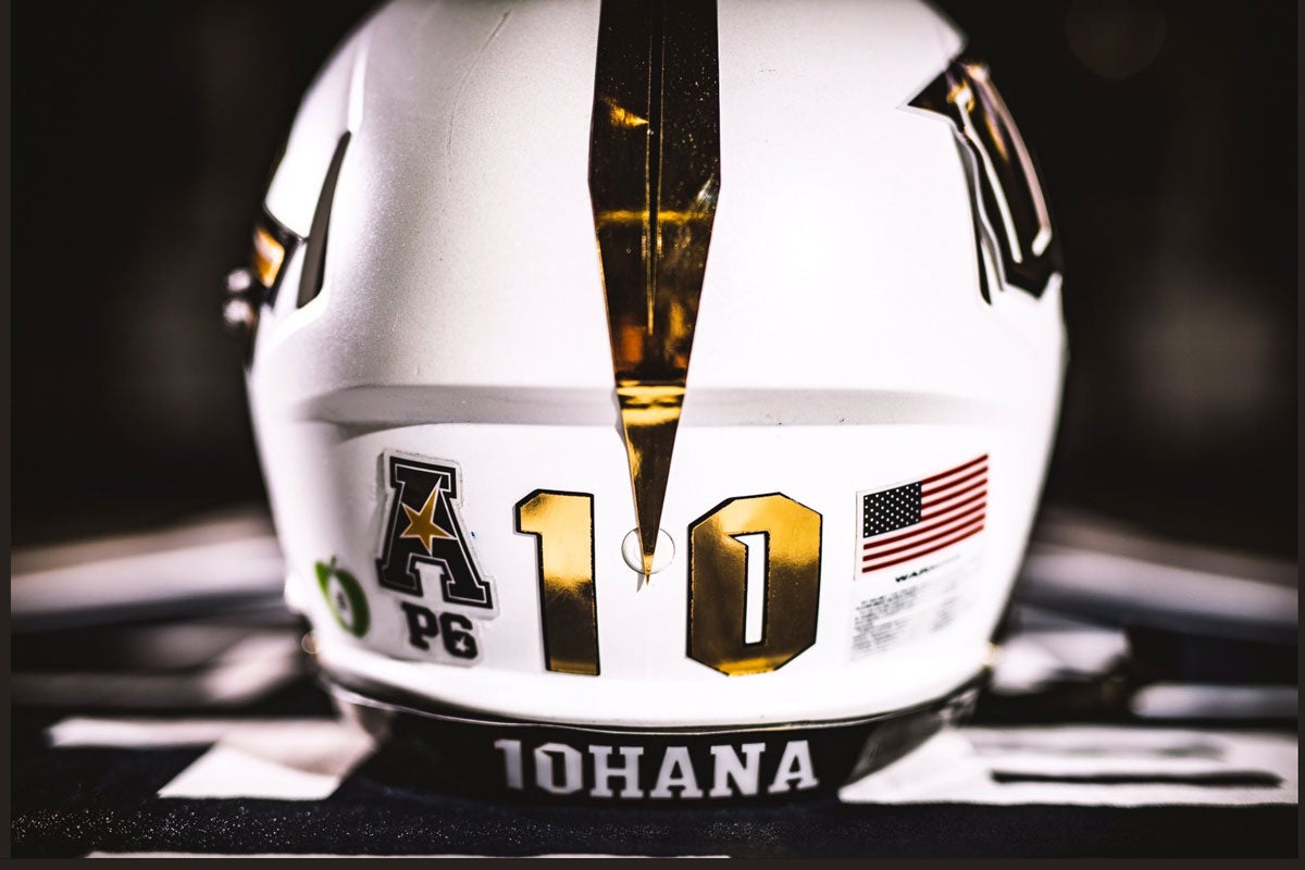 backside of white football helmet with a gold 10 and 10HANA written along the bottom