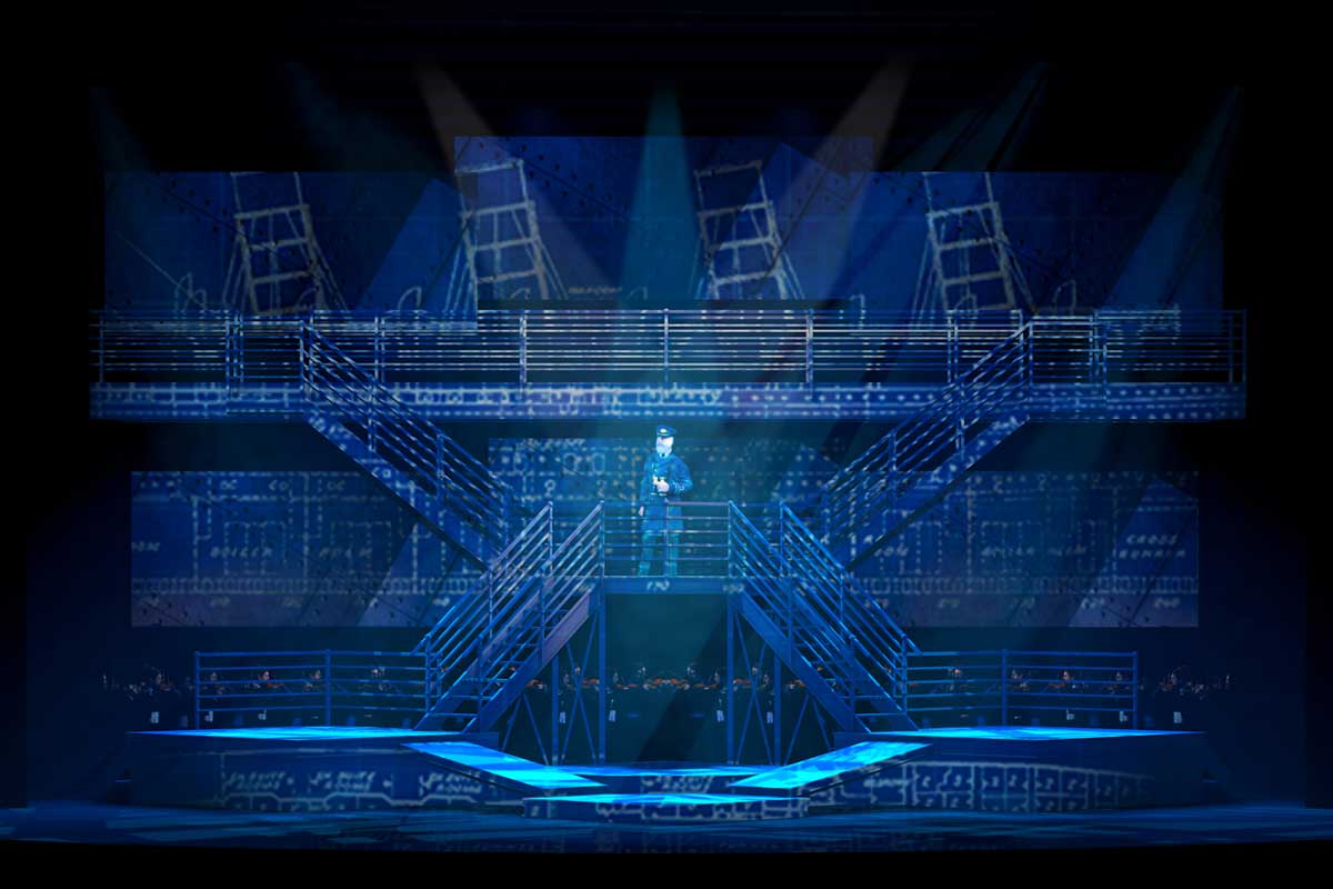 Blue stage set with a captain of a ship on a set of stairs