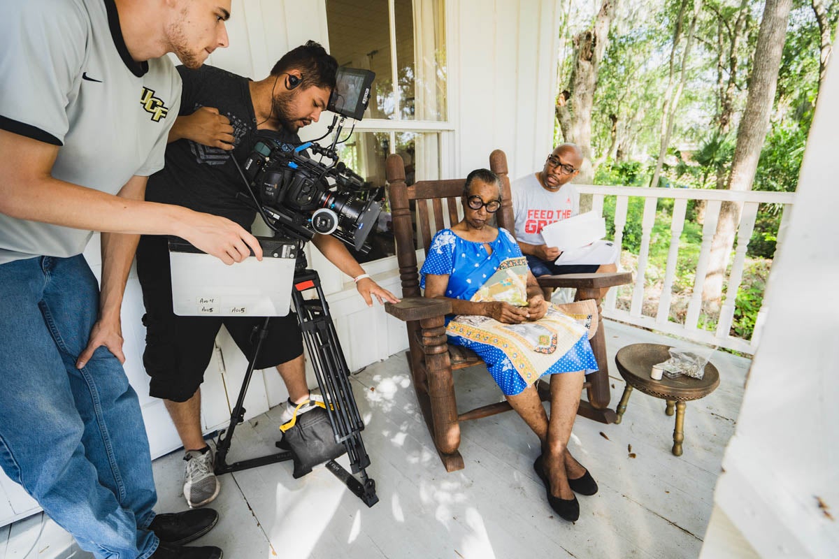 Graduate student Jason Gregory (right) helps set up a shot during the filming of his TV pilot "Waking Up White." (Photo courtesy of Jason Gregory)