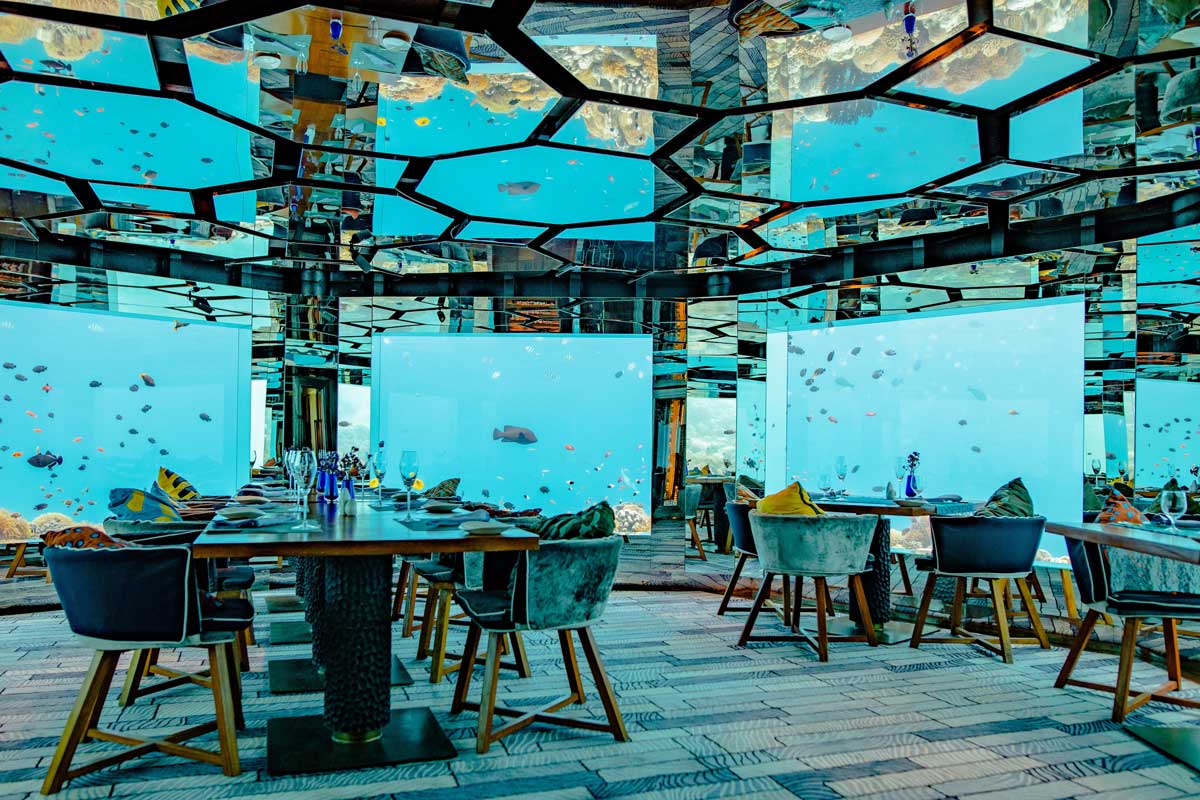 A restaurant enclosed by glass and underwater