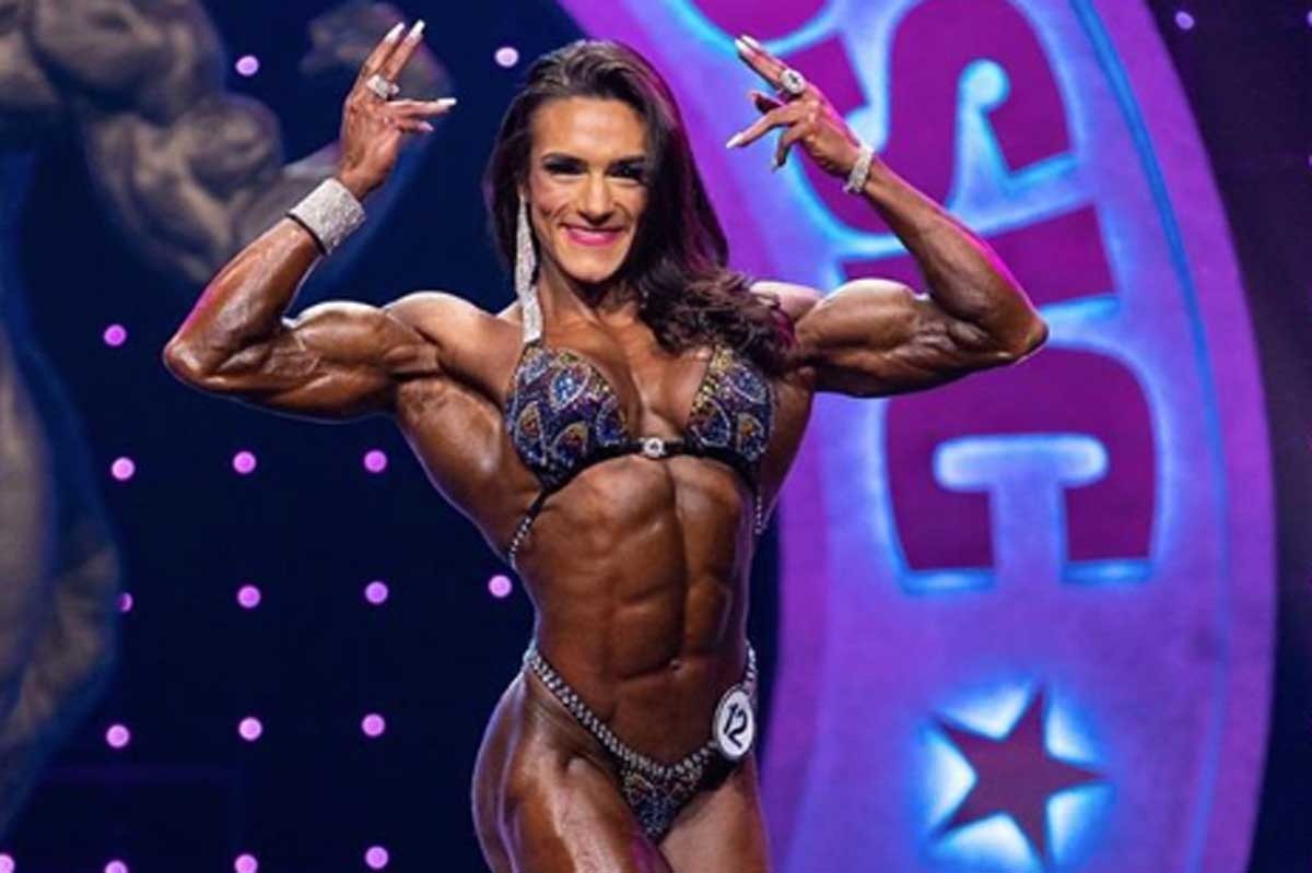 Female bodybuilder poses while flexing