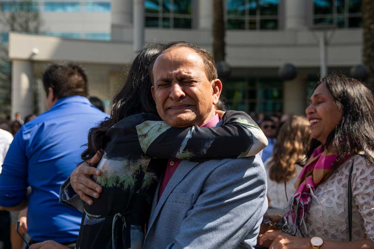 Man hugs daughter and cries with pride