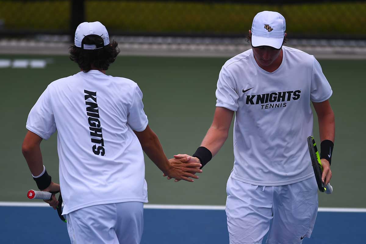 two tennis players high five on court