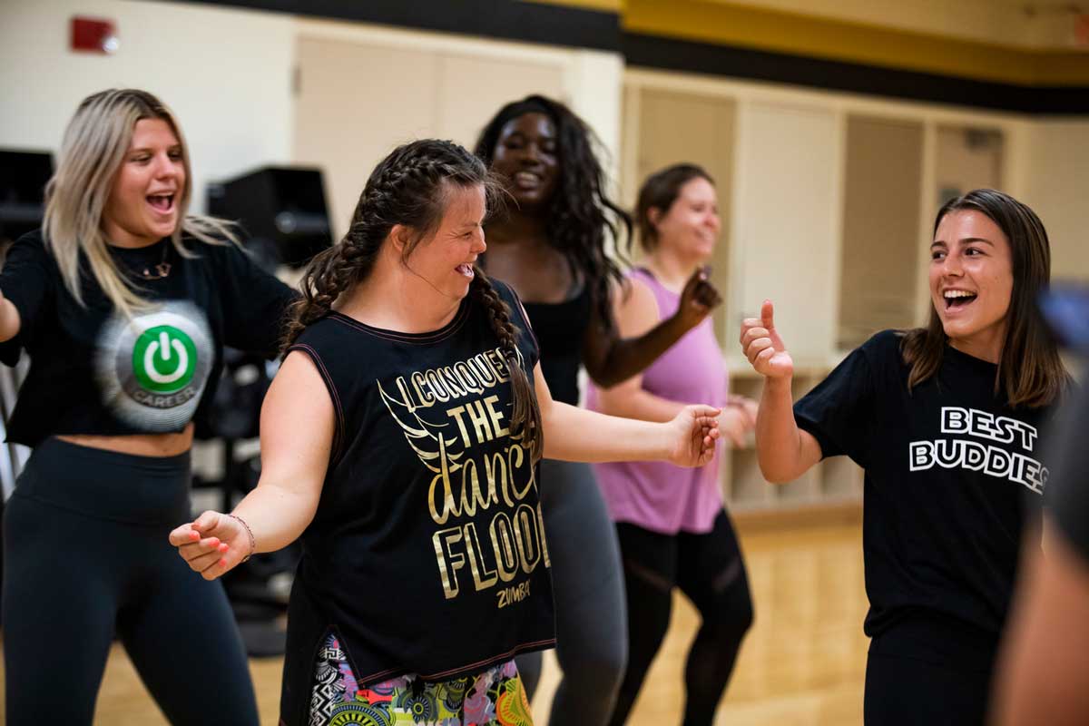 Group of women dance in fitness studio