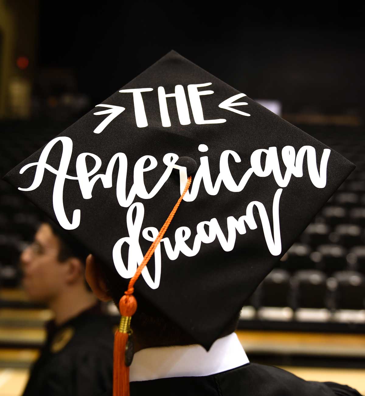 Grad cap decorated with text: The American Dream