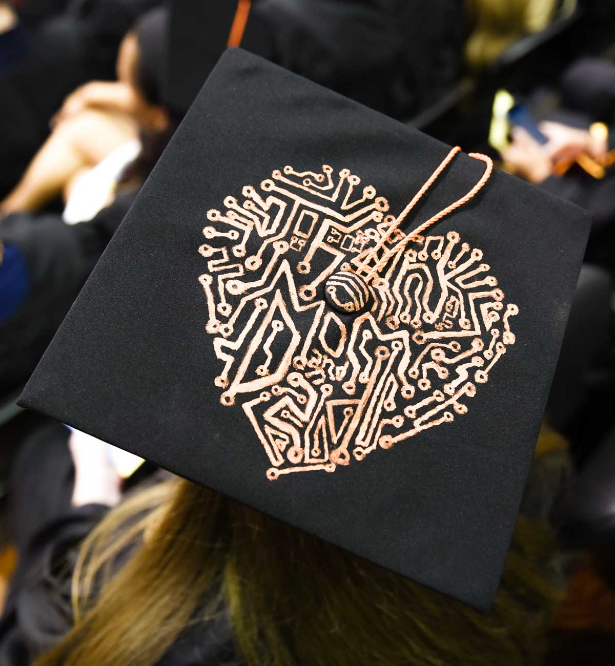 Grad cap decorated with gold heart made of intricate lines