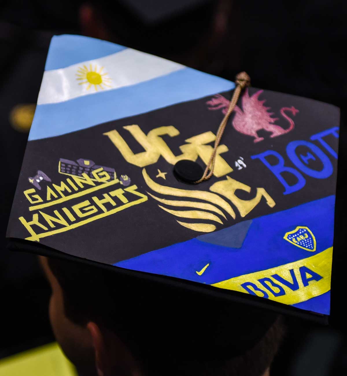 Grad cap decorated with Gaming Knights and UCF pegasus logo